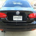 Before and after photographs of a damaged black Volkswagon Jetta that was repaired by Elite Paint & Body Shop in West Palm Beach, Florida.
